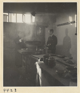 Kitchen of Niu Rou Wan, a Muslim grilled-beef restaurant, showing two men