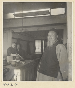 Kitchen of Niu Rou Wan, a Muslim grilled-beef restaurant, showing the proprietor and two workers