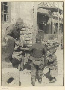 Street vendor at a food stand watching two boys eating