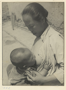 Woman nursing a child