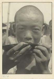 Man eating at a food stand