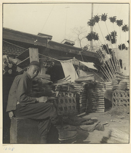 Man selling brooms and feather dusters