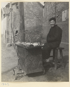 Street vendor selling food from a cart painted with decorative scenes