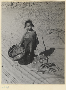 Girl with basket and rake
