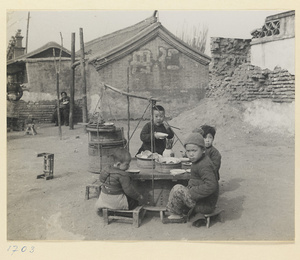 Four children eating at a food stand