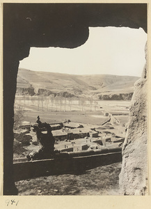 View from a cave at Yun'gang showing houses, fields, and hills