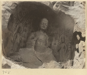 Detail of Wuzhou Cliff at Yun'gang showing cave entrance with statues of Buddha and attendants