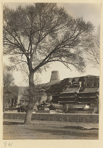 General view of east end of the Yun'gang Caves showing adobe tower in Spirit Wall, Wuzhou Cliff, and temple buildings