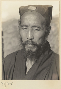 Daoist priest wearing a cap with a jade plaque on Hua Mountain