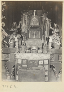 Altar with statues, vessels, inscriptions, and embroidered votive offerings in a Daoist temple on Hua Mountain