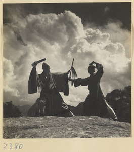 Daoist priests with a sword and a yak-tail fly whisk performing a ceremonial dance on East Peak of Hua Mountain