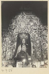 Detail of an altar showing a statue of the goddess Sheng Mu wearing a phoenix headdress and a mantle embroidered with eight trigrams in a Daoist temple on Hua Mountain