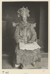 Temple interior showing seated figure with headdress, robe, shoes, and inscribed pillow on Tai Mountain