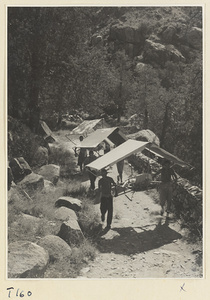 Men carrying sedan chairs with awnings up Tai Mountain