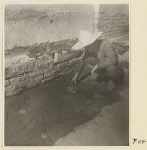 Man working with pieces of clay on a street in Tai'an