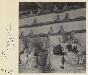 Interior of a temple building at Ling yan si showing statues of Luohans and figurines of Buddhas