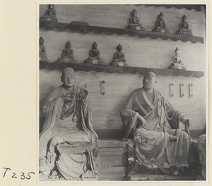 Interior of a temple building at Ling yan si showing statues of Luohans and figurines of Buddhas