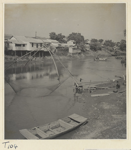 Man fishing with a large net on the river at Tai'an