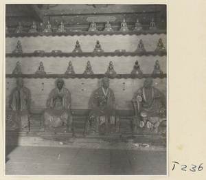 Interior of a temple building at Ling yan si showing statues of Luohans and figurines of Buddhas