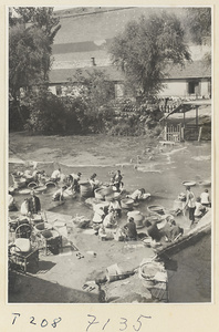 Village women washing clothes in the river at Ji'nan