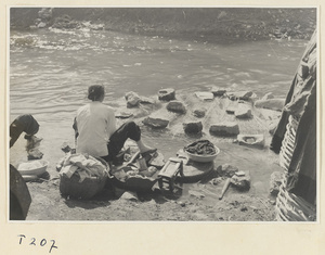 Village women washing clothes in the river at Ji'nan