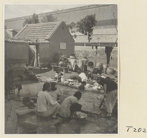 Village women washing clothes in the river at Ji'nan