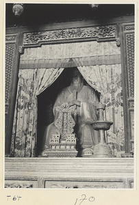 Statue of Confucius with imperial sceptre, soul tablet (left), and candlestick (right) in Da cheng dian at Kong miao