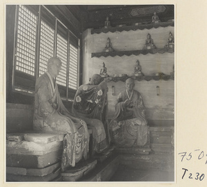 Interior of a temple building at Ling yan si showing statues of Luohans and figurines of Buddhas