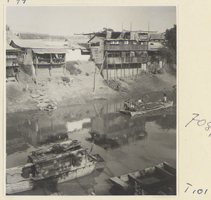 Boats on the river at Tai'an and houses with porches on stilts in the background