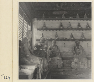 Interior of a temple building at Ling yan si showing statues of Luohans and figurines of Buddhas