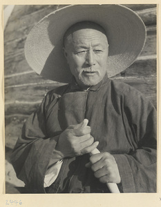 Village elder standing next to a junk on the Shandong coast