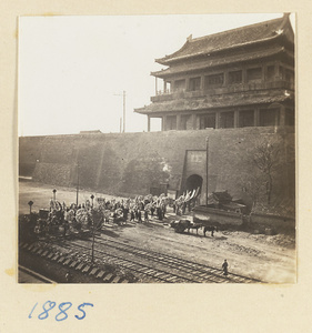 Funeral procession passing through a city gate