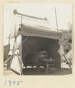 Simple coffin and altar under a mat shed