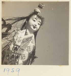 Paper figure of a woman with a yun luo in a funeral procession