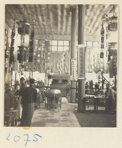 Members of a wedding party in pavilion with lanterns, drums, litter, hanging scrolls, and banners