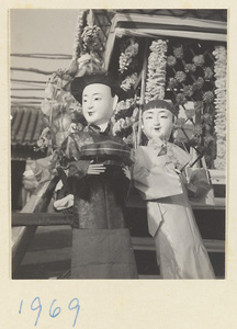 Paper figures of male and female servants in a funeral procession