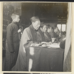 Daoist priests with musical instruments chanting at funeral service