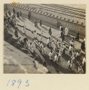 Members of a funeral procession carrying paper figures