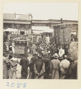 Members of a wedding procession carrying sedan chair, umbrella, and fan-shaped screen