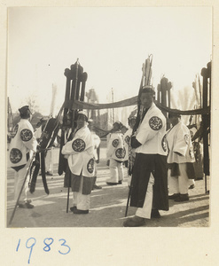 Members of a funeral procession carrying banners