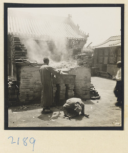 Pilgrims burning incense in a brick incense burner on Miaofeng Mountain