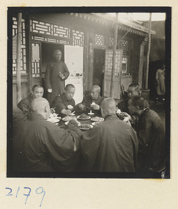 Monks at a table eating on Miaofeng Mountain