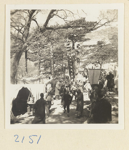 Pilgrims and temple society members who perform a flagpole balancing show called hong fan hui on the trail up Miaofeng Mountain