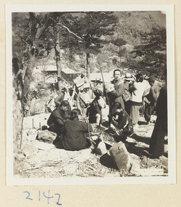 Pilgrims with peach-wood walking sticks buying souvenirs on Miaofeng Mountain