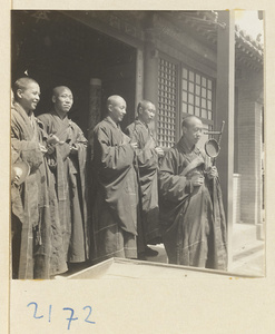 Monks with musical instruments at temple entrance on Miaofeng Mountain