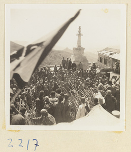 Pilgrims with flags next to the stupa-style pagoda on Miaofeng Mountain