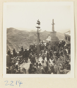 Pilgrims watching temple society members performing a flagpole balancing show called zhong fan hui beside the stupa-style pagoda on Miaofeng Mountain
