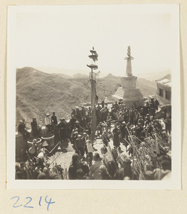 Pilgrims watching temple society members performing a flagpole balancing show called zhong fan hui beside the stupa-style pagoda on Miaofeng Mountain