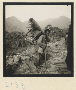 Pilgrim with walking stick and backpack on Miaofeng Mountain