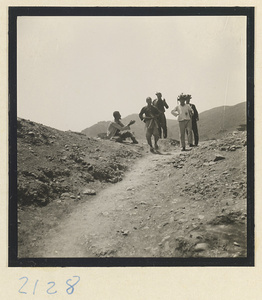 Pilgrims wearing sourvenir hats on the trail down Miaofeng Mountain